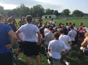 Dowling Catholic Head Football Coach Tom Wilson address his team before team camp in July, 2014. Image via DCHS Football Facebook Page.